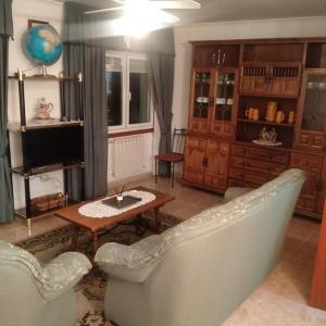 a living room with a couch and a table and a tv at A Casa da Esquina in Portomarin