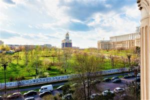 a view of a city with cars parked in a parking lot at Parliament Merlot Unirii Square 5 Bedrooms Luxury Apartment Old Town in Bucharest