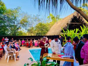 a bride and groom are standing in front of a crowd at Mariposa Jungle Lodge in San Ignacio +174 photos