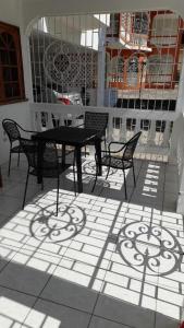 a black table and chairs on a patio at Melrose Place in Montego Bay