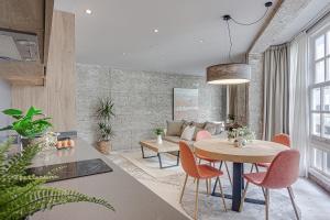 a living room with a table and chairs and a couch at Metropolitan Boutique in A Coruña