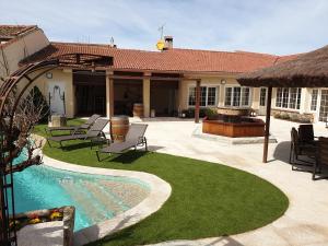 un patio trasero con piscina y una casa en La Casa del Solaz, en Anaya