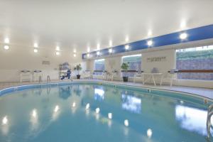 a large swimming pool in a hospital building at Wingate by Wyndham Sioux City in Sioux City