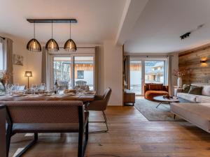 a dining room and living room with a table and chairs at Mountain Chalet Arnica in Sankt Lorenzen ob Murau