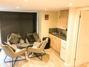 a kitchen with chairs and a table in a kitchen at Badgers Sett 2 Bedroom sleeps 4, The New Inn Viney Hill, Forest of Dean in Blakeney