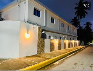 un edificio blanco con luces en el costado en Noe Hotel ,1 Bed Room 2 Near to the beach en Punta Cana