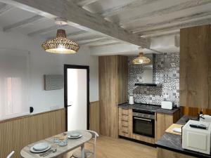 a kitchen with two chandeliers and a table at Loft Playa Villajoyosa in Villajoyosa