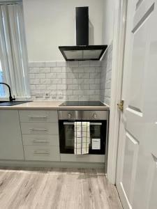 a kitchen with a stove top oven in a kitchen at Large, stylish 2bedroom apartment l free parking in Elswick