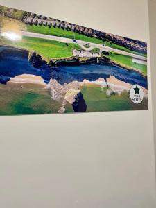 a painting of a golf course on the wall at Large, stylish 2bedroom apartment l free parking in Elswick