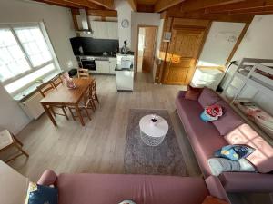 a living room with a purple couch and a kitchen at Sky Apartments in Rust