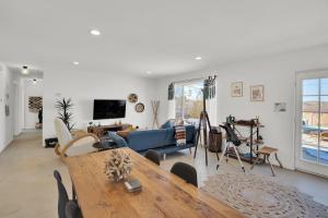 a living room with a table and a blue couch at The Quail's Nest, Dreamy Backyard,10 Mins To Jtnp in Joshua Tree