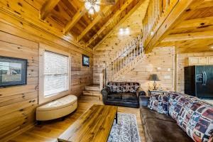 a living room with a couch and a table in a cabin at Jolene Jolene in Pigeon Forge