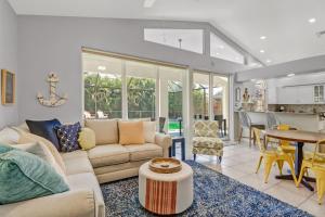 a living room with a couch and a table at Cozy Beach House - 5 minutes from Vanderbilt Beach in Naples