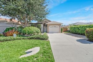 uma entrada que leva a uma casa com uma árvore em Cozy Beach House - 5 minutes from Vanderbilt Beach em Naples