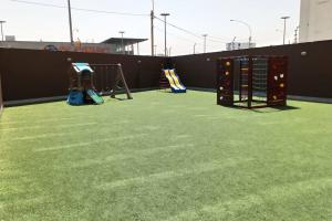 a playground with swings and a play equipment at Gorgeous 2 bedroom flat in nice commercial area in Lima