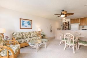 a living room with a couch and a table at Sea Village #3202 in Kailua-Kona