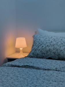 a bedroom with a bed with a lamp on a table at Panorama Jerash HOTEL (2) in Jerash