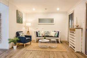 a living room with a couch and a chair at Rooftop Retreat in Dunsborough
