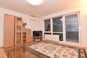 an empty living room with a large window at Modern Apartment at VIC in Vienna