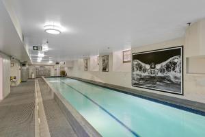 a large swimming pool in a building at Eve Apartment - Cathedral Square in Christchurch