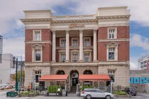 un edificio con un'auto parcheggiata di fronte di Eve Apartment - Cathedral Square a Christchurch