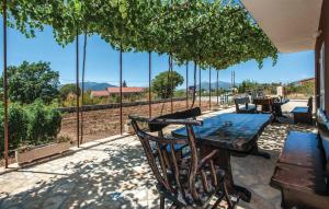 a wooden table and chairs on a patio with a view at House Fun&Relax in Šestanovac