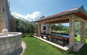 a wooden pavilion with a bench in a yard at House Fun&Relax in Šestanovac