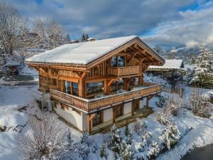a large wooden house with snow on the roof at Chalet Demi-Quartier, 7 pièces, 12 personnes - FR-1-569-19 in Demi-Quartier