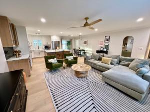a living room and kitchen with a couch and a table at Casa Gia- Quiet Luxury Biltmore Area - Heated Pool in Phoenix