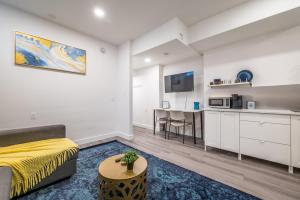 a living room with a bed and a kitchen at Spacious Newly Renovated 1 Bedroom Suite in Halifax