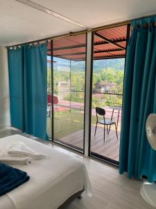 a bedroom with a bed and a view of a patio at Minca Seasons in Minca