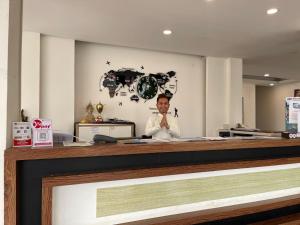 a man sitting at a counter in a room at VANG VIENG TOPVIEW HOTEL in Vang Vieng +111 photos