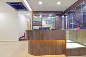 an office lobby with a wooden reception desk at 4S Hotel in Muar