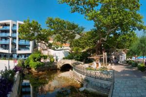 a bridge over a river next to a building at Apartments in Mlini 44021 in Mlini