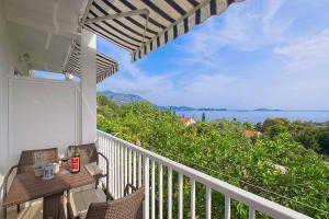 a balcony with a table and a view of the ocean at Apartments in Mlini 44021 in Mlini +21 photos