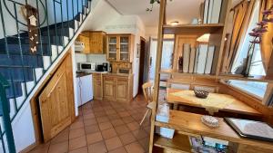 a small kitchen with a table and a staircase at Apartment in Bad Waltersdorf - Steiermark 44009 in Bad Waltersdorf