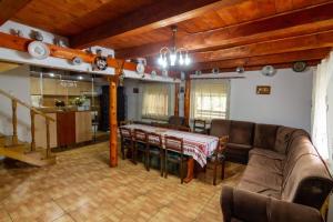 a living room with a couch and a table at Casa Cornel in Vartop