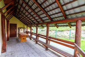 a porch of a building with a wooden roof at Casa Cornel in Vartop