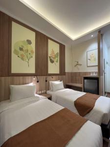 Postel nebo postele na pokoji v ubytování D'Bamboo Suites