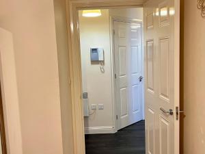 a hallway with a door leading to a room at Radiant2 bedroom apartment in the heart of Harlow town in Harlow