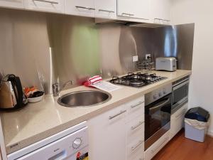 a kitchen with a sink and a stove at Alto 203 in Mount Buller