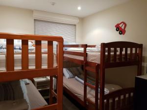 a bedroom with two bunk beds and a window at Alto 203 in Mount Buller