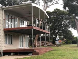 a house with a large porch on top of it at Eagles Nest in Merrijig