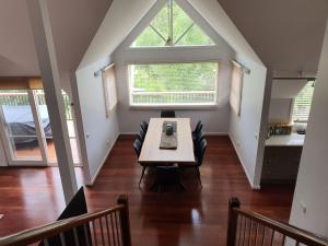 a dining room with a table and a window at Jarrah Lodge in Merrijig