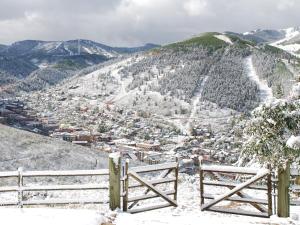 a view of a snowy mountain with a fence at Treasure Mountain Inn in Park City