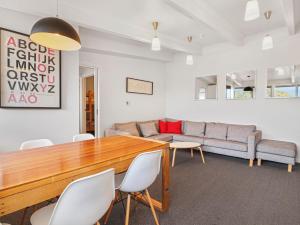 a living room with a table and chairs and a couch at SKI View 4 in Mount Buller