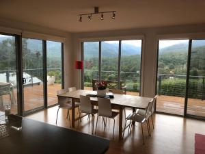 a dining room with a table and chairs with a view at Stirling View in Merrijig