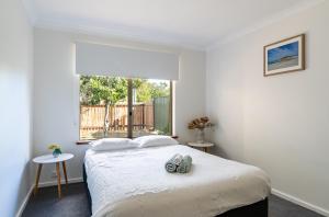 a bedroom with a bed and a large window at Double J's in Margaret River Town