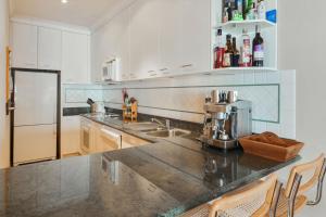 a kitchen with white cabinets and a counter top at Mawson 5 in Mount Buller