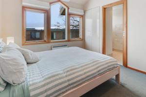 a bedroom with a large bed and a window at Mawson 5 in Mount Buller
